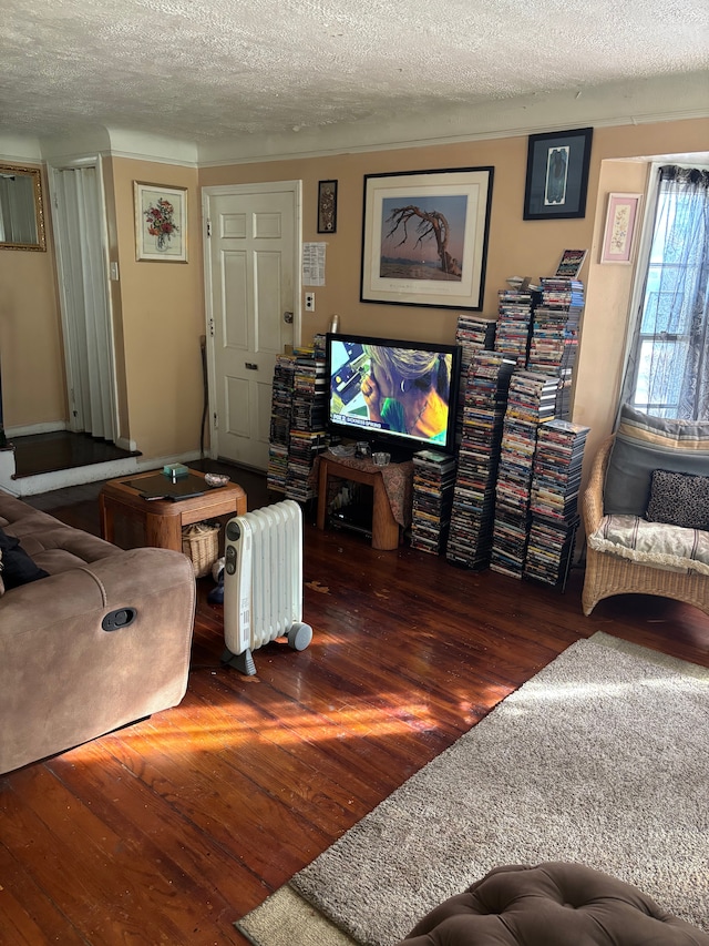 living room with hardwood / wood-style flooring and a textured ceiling