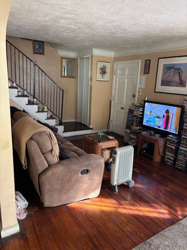 living room featuring wood-type flooring, stairway, and a textured ceiling