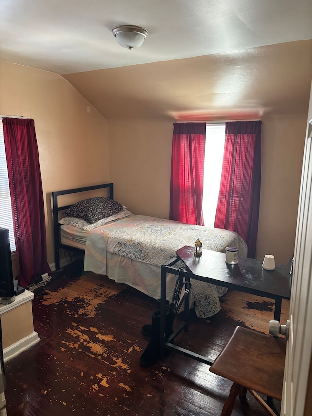 bedroom featuring vaulted ceiling and wood finished floors