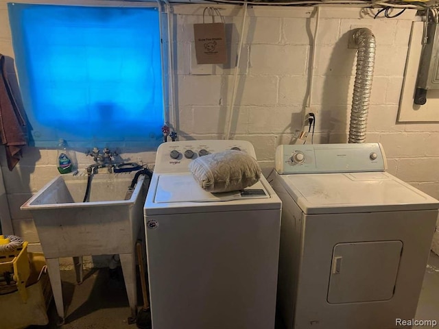 washroom featuring washing machine and dryer and sink