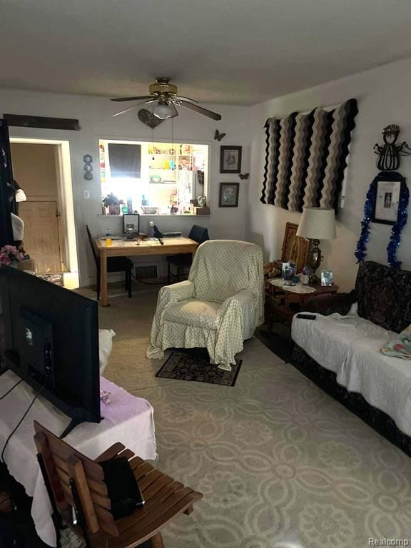 living room with ceiling fan and light colored carpet