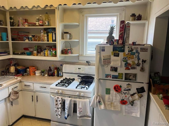 kitchen featuring white appliances and white cabinets