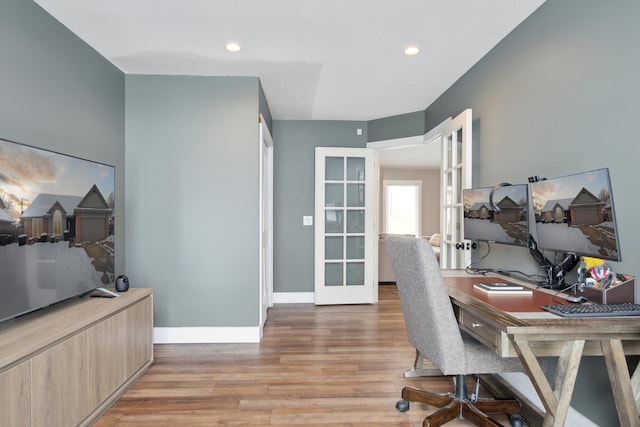 home office with recessed lighting, baseboards, and light wood finished floors