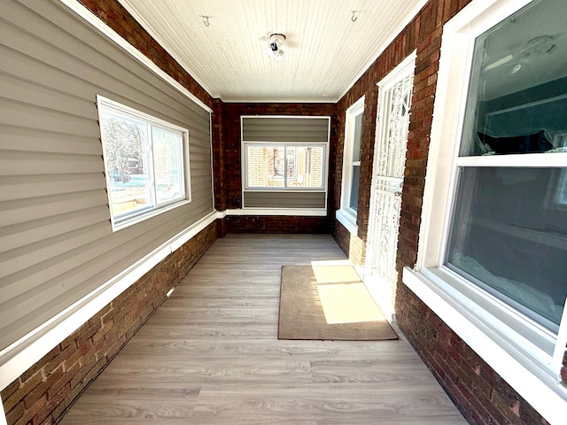 unfurnished sunroom with wooden ceiling