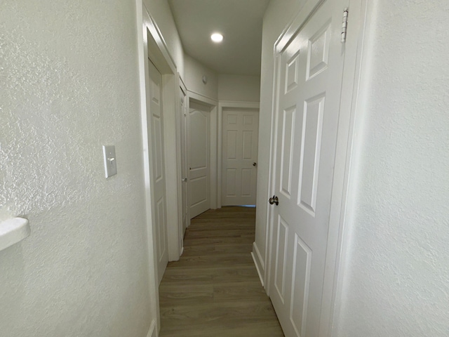 corridor with light wood-type flooring