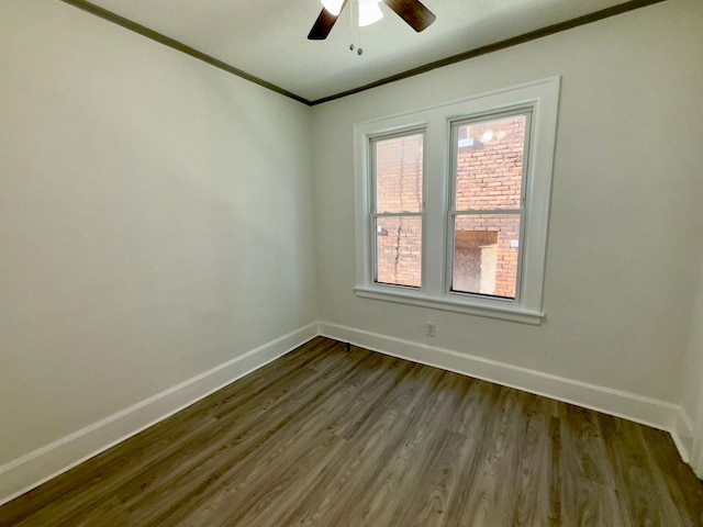 empty room with ceiling fan, ornamental molding, and wood-type flooring