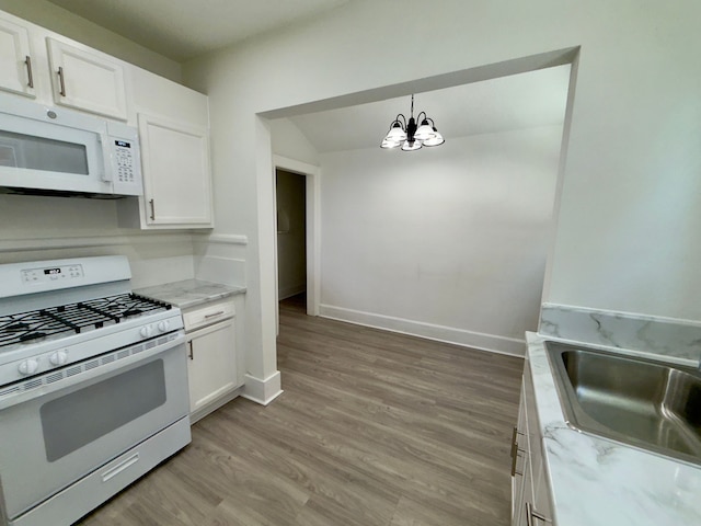 kitchen featuring white cabinetry, sink, and white appliances