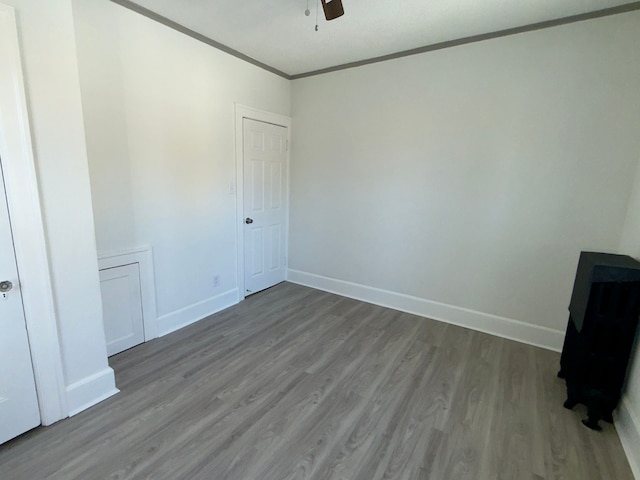 unfurnished room featuring crown molding, ceiling fan, and light hardwood / wood-style flooring