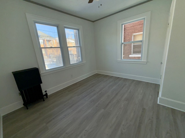 unfurnished room featuring crown molding, light hardwood / wood-style flooring, and ceiling fan