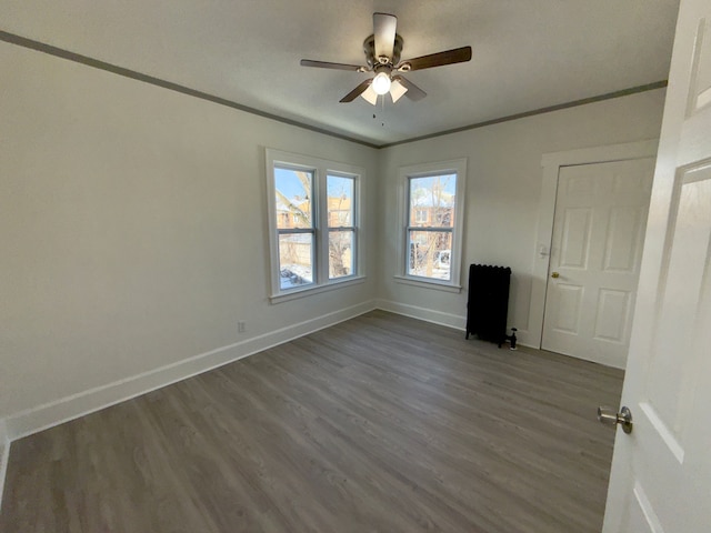 unfurnished room featuring ceiling fan, ornamental molding, and wood-type flooring