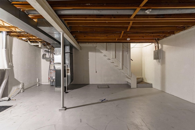 basement featuring heating unit and electric panel