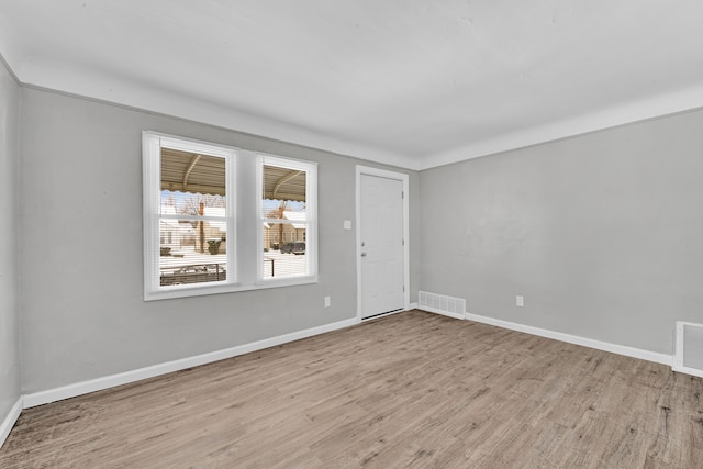 spare room with light hardwood / wood-style floors