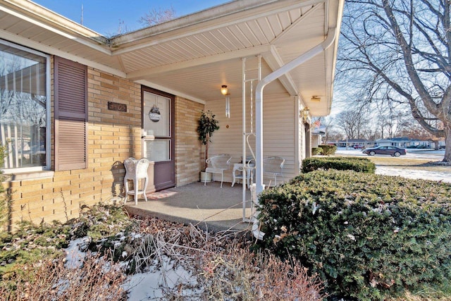 view of exterior entry featuring covered porch