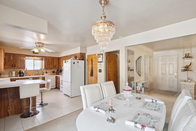 tiled dining room featuring ceiling fan with notable chandelier