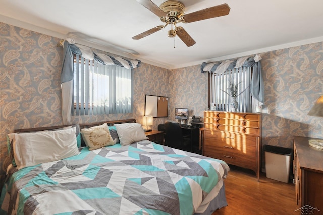 bedroom with crown molding, wood-type flooring, and ceiling fan