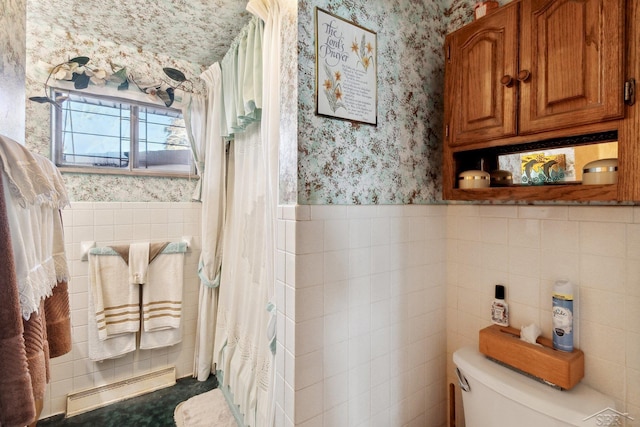 bathroom with a baseboard radiator, tile walls, walk in shower, and toilet