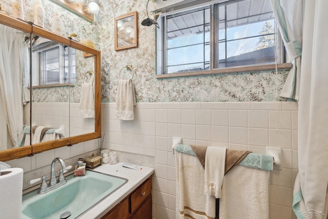 bathroom featuring vanity, tile walls, and a wealth of natural light