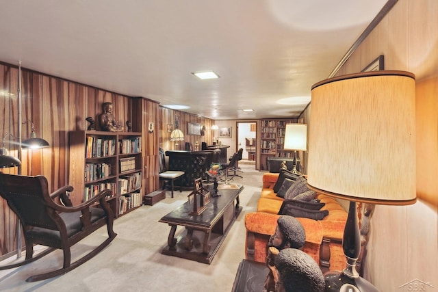 carpeted living room featuring wood walls and bar area