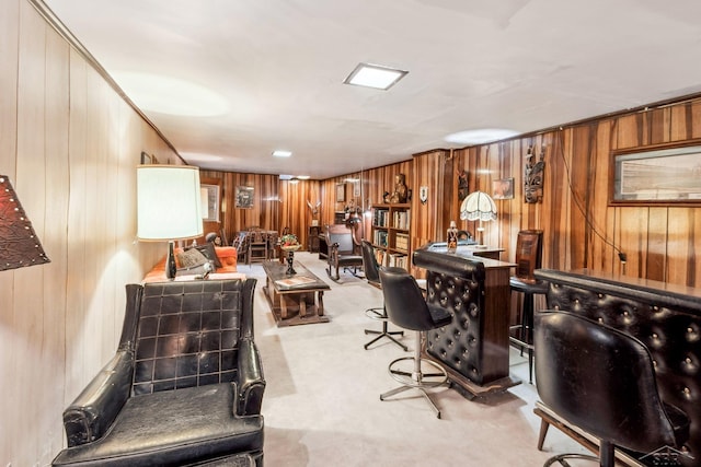 carpeted home office featuring bar and wooden walls