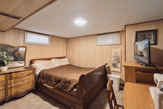 bedroom featuring wooden walls and light wood-type flooring