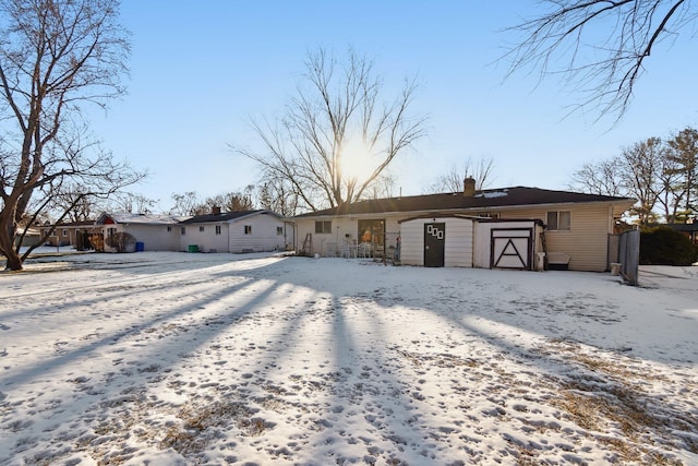 single story home with a shed