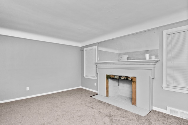 unfurnished living room featuring carpet floors