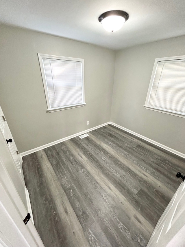 spare room featuring dark hardwood / wood-style floors