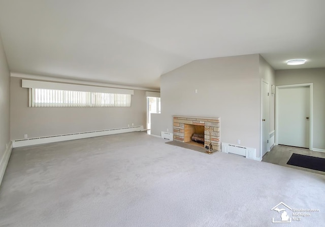 unfurnished living room with vaulted ceiling, a stone fireplace, a baseboard heating unit, and plenty of natural light