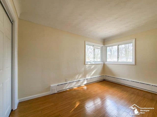 spare room with hardwood / wood-style floors