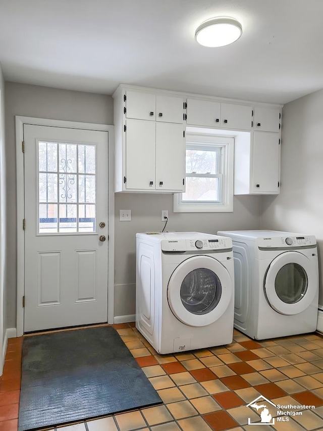 laundry room with independent washer and dryer and cabinets