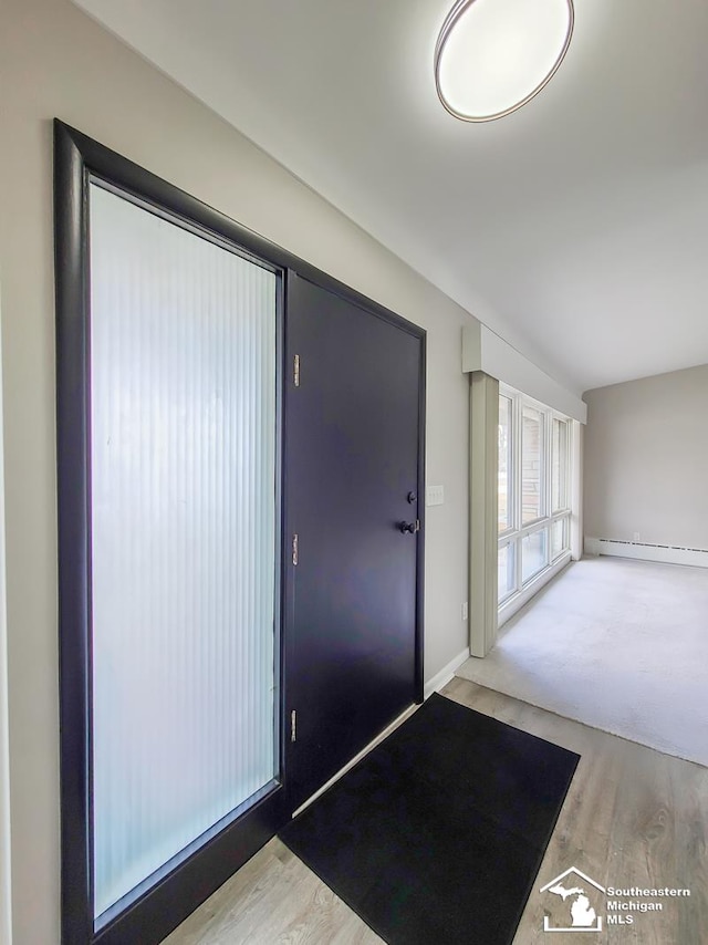 entryway featuring light hardwood / wood-style floors and baseboard heating