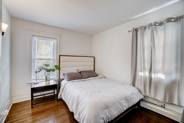 bedroom featuring dark wood-type flooring and a baseboard radiator