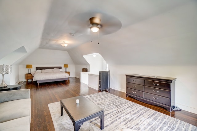 bedroom featuring vaulted ceiling, dark hardwood / wood-style floors, and ceiling fan