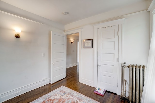 bedroom featuring dark hardwood / wood-style floors and radiator heating unit