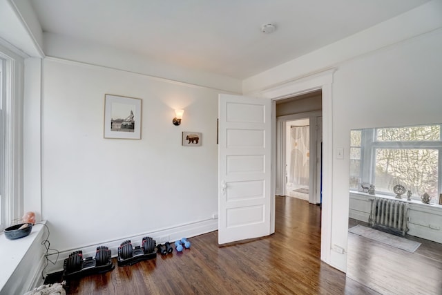 interior space with radiator and dark wood-type flooring