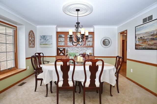 dining area featuring visible vents, crown molding, and light colored carpet