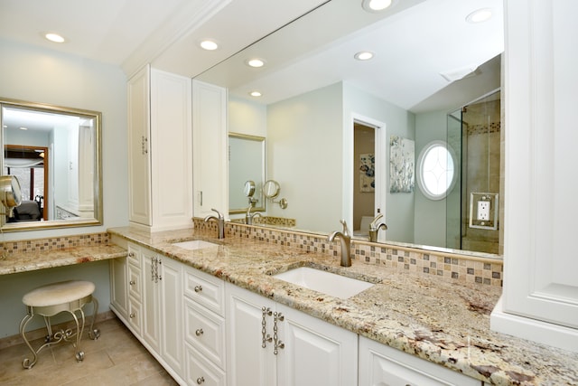 full bath featuring backsplash and a sink