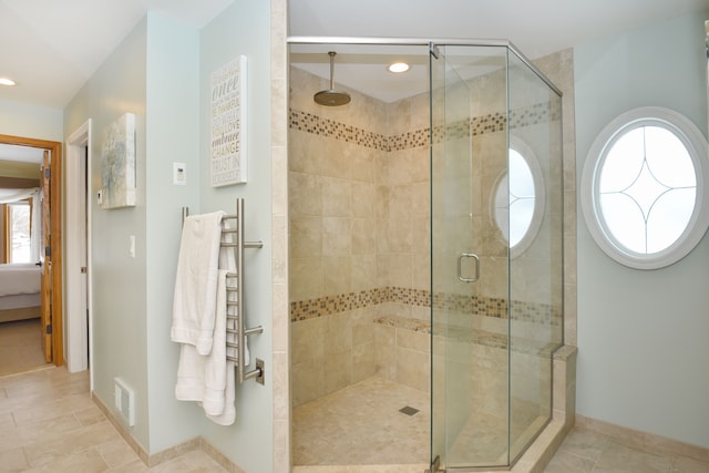 bathroom featuring ensuite bath, a stall shower, plenty of natural light, and visible vents