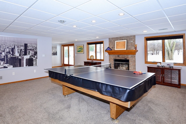 playroom with light carpet, visible vents, baseboards, a drop ceiling, and a fireplace