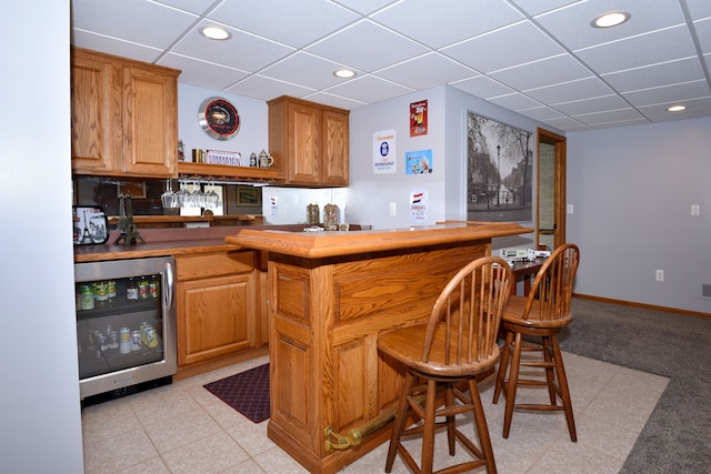 bar with a dry bar, wine cooler, a drop ceiling, and recessed lighting