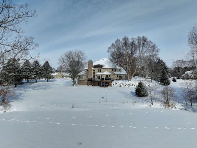 snowy yard featuring a wooden deck