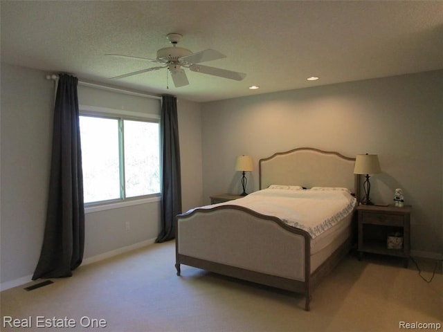 bedroom with light colored carpet and ceiling fan