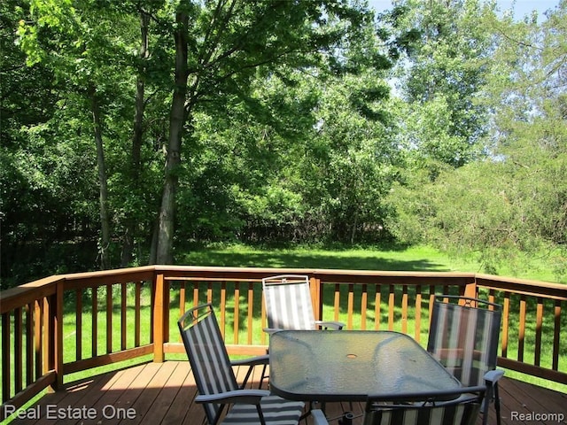 wooden deck featuring a yard