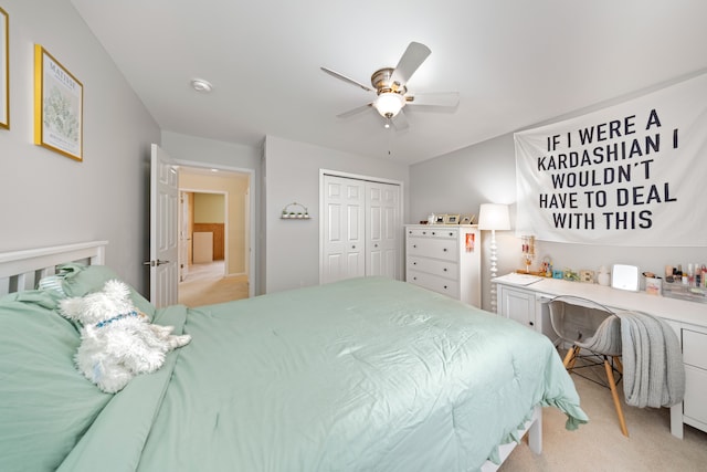 carpeted bedroom with ceiling fan and a closet