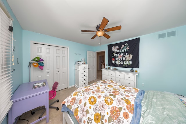 carpeted bedroom with ceiling fan and a closet