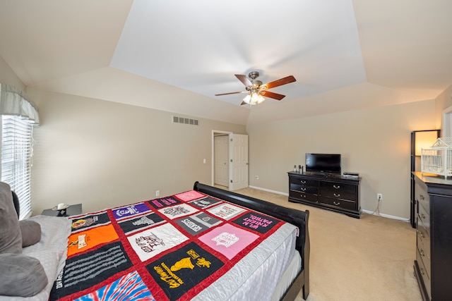 bedroom featuring ceiling fan, lofted ceiling, and light carpet