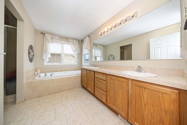 bathroom featuring vanity, tile patterned floors, and shower with separate bathtub