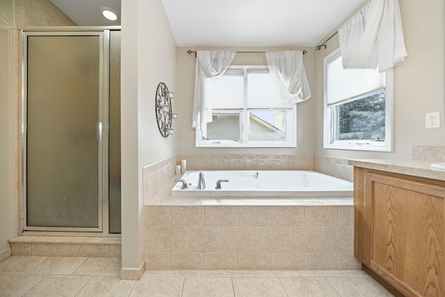 bathroom with tile patterned flooring, plus walk in shower, and plenty of natural light