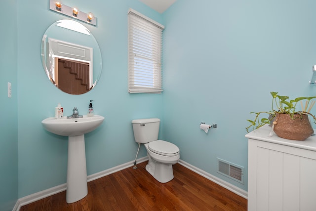 bathroom featuring hardwood / wood-style flooring and toilet