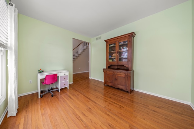 office with light wood-type flooring